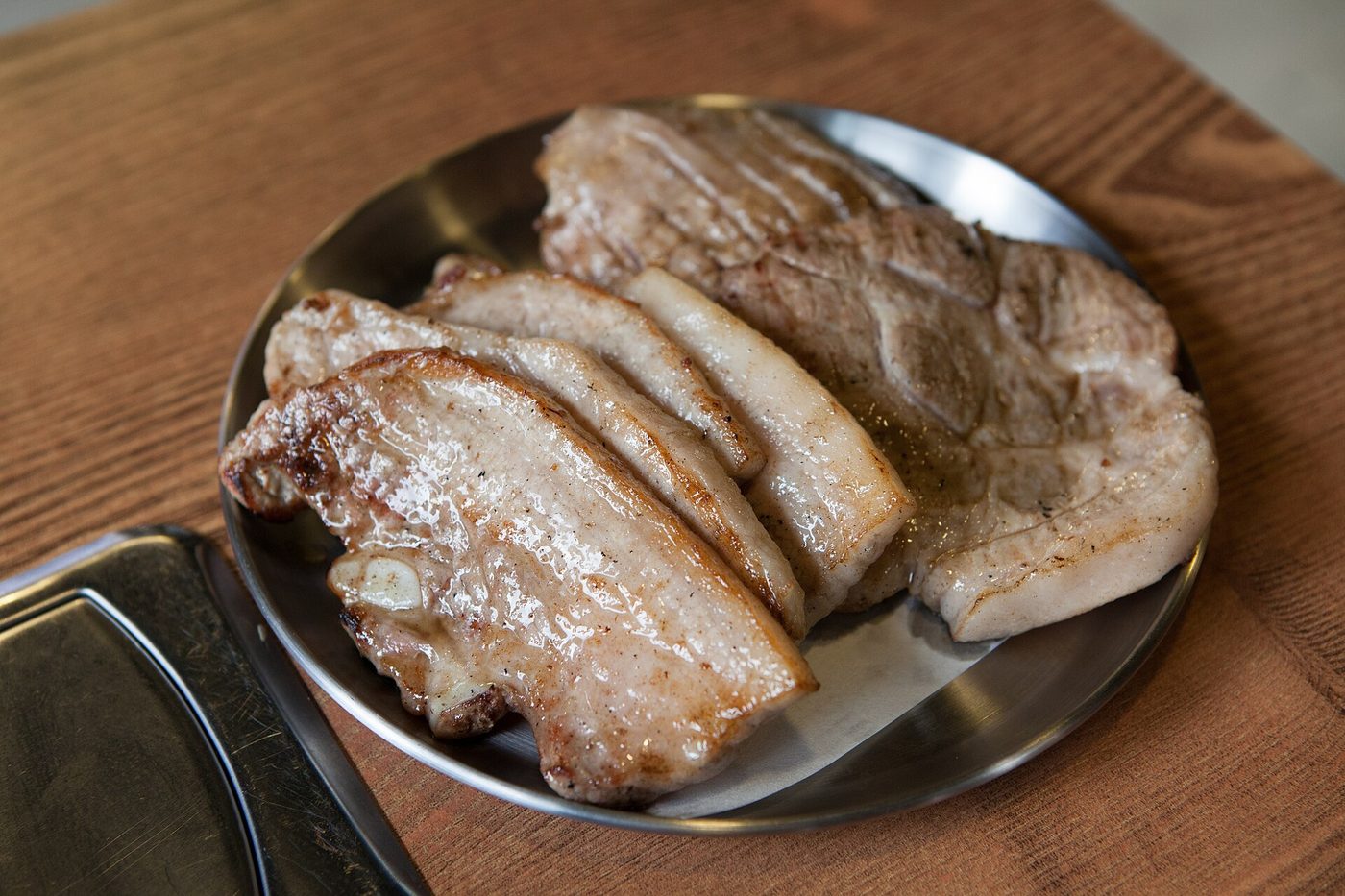 Tranches de porc grillé sur assiette en métal